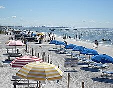 fort myers beach with umbrellas and people