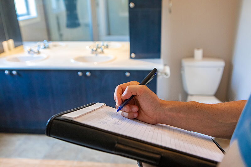 person taking notes in a rental house