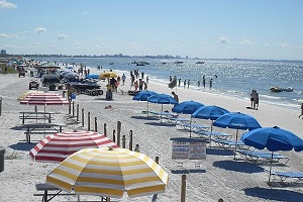 fort myers beach with umbrellas and people